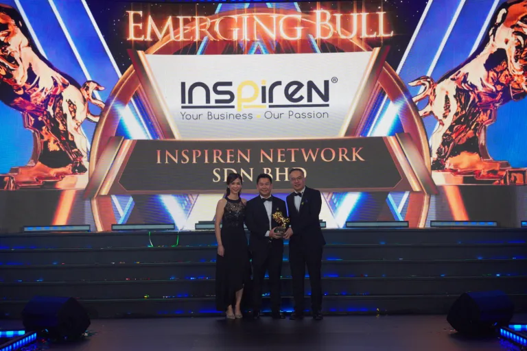 Inspiren Network CEO receiving emerging bull award on stage