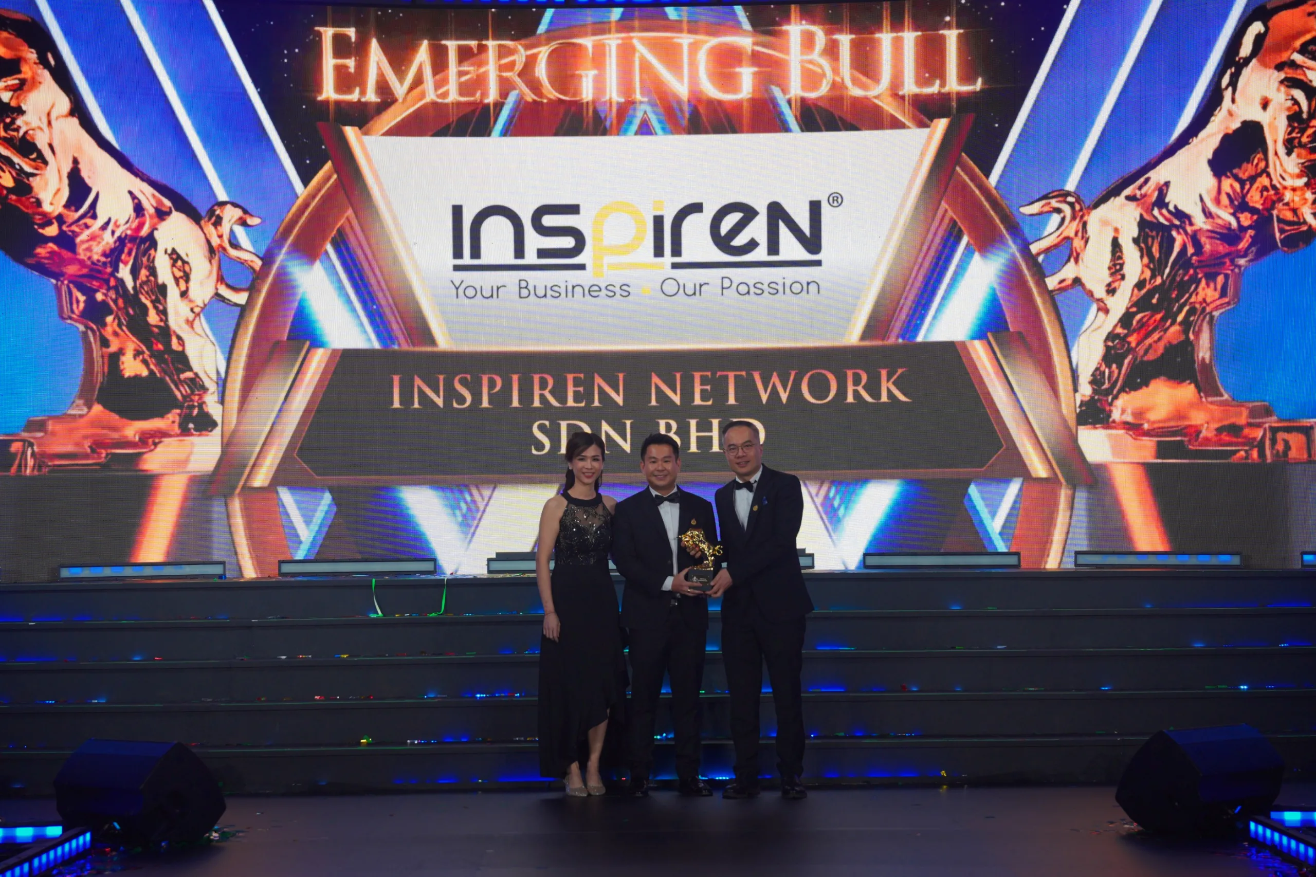 Inspiren Network CEO receiving emerging bull award on stage