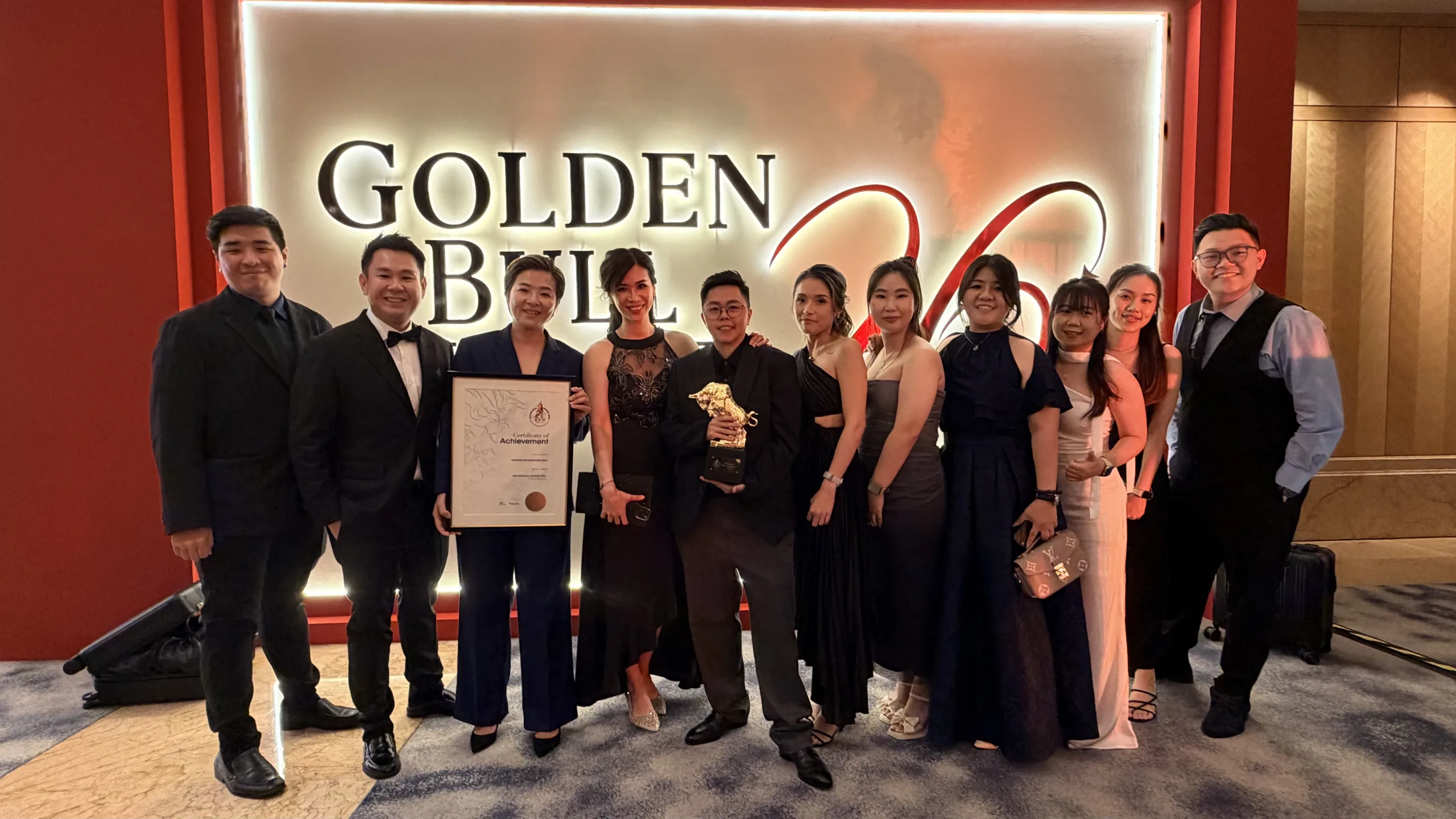 Inspiren Network leaders and team members holding the Emerging Bull Award 2026 trophy and certificate